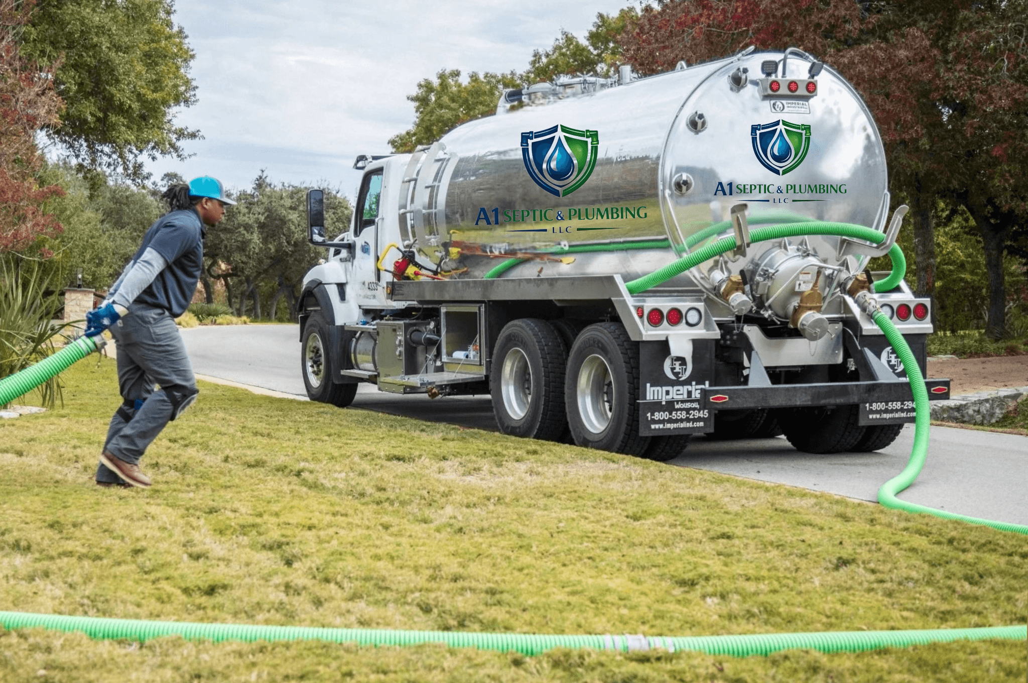 Worker pulling a green hose from an A1 Septic & Plumbing truck across a lawn.